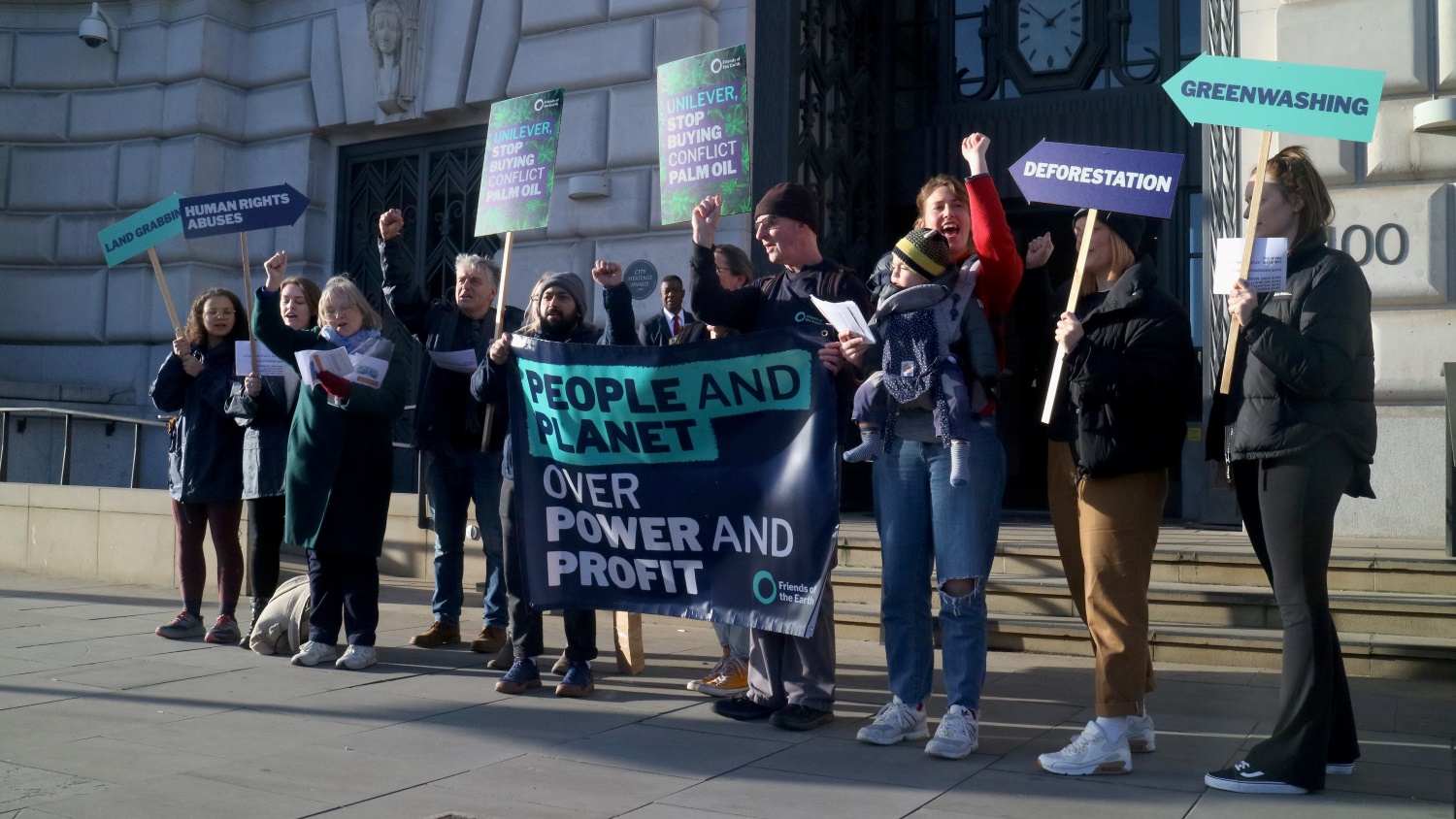 Image of activists holding banners at protest targeting Unilever