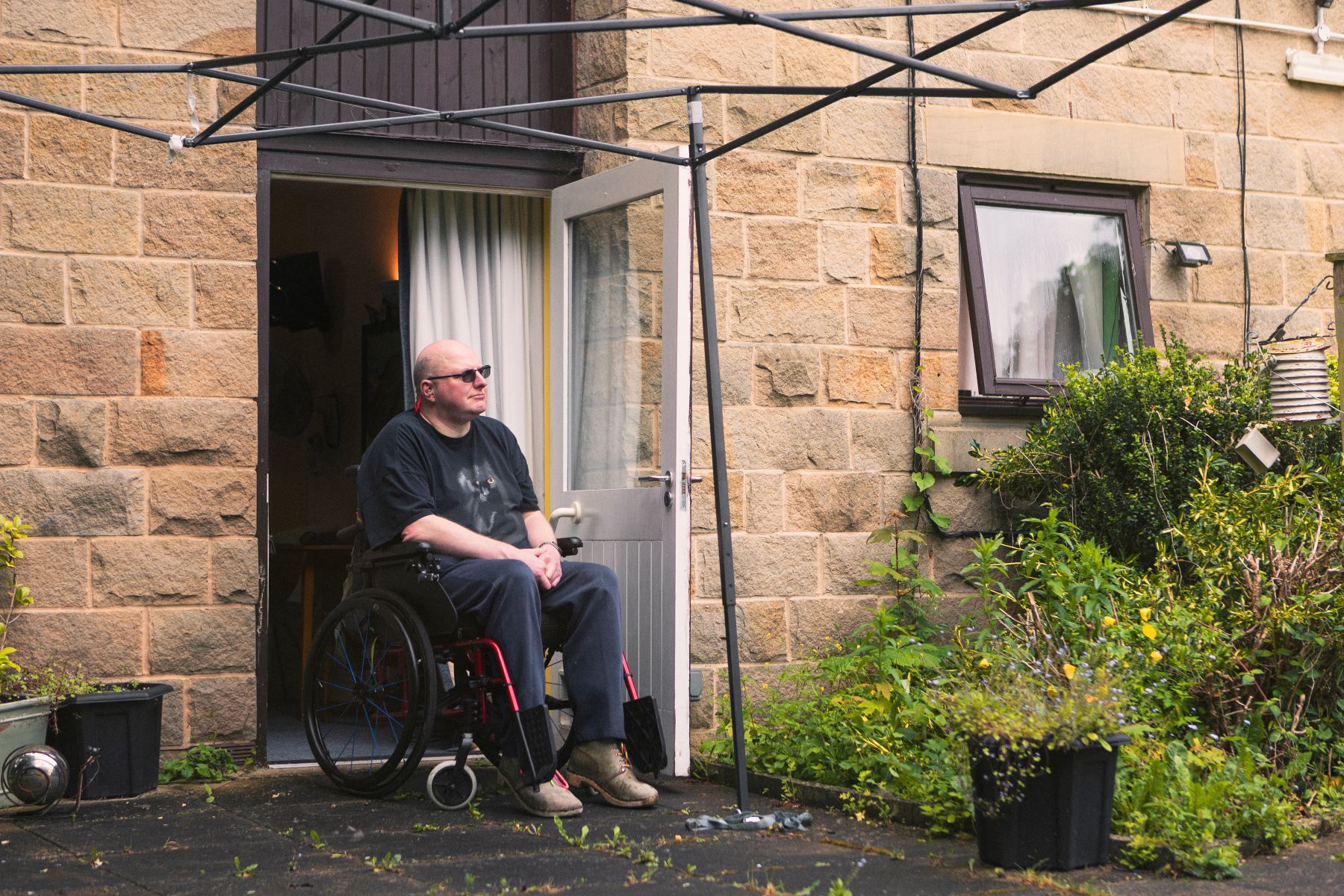 Disabled activist and co-claimant in court case in front of his home